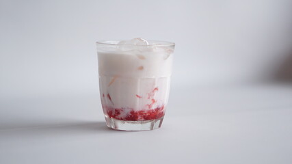 a glass of strawberry jam milkshake