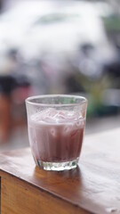a glass of strawberry jam milkshake