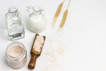 Obraz na płótnie Canvas Flour in scoop and glass jar.