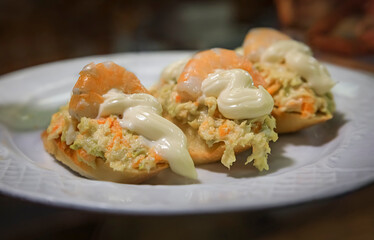 Spanish pintxos Russian salad with shrimp in a Basque bar, San Sebastian, Spain