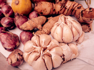 Various kinds herbs and spices. Fresh Onions, garlic, turmeric, galangal, Bay leaf, lime. as a kitchen spice