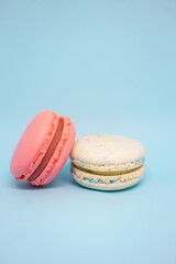 pink and blue macarons on a blue background. delicious fresh dessert. monochrome. color of the year.