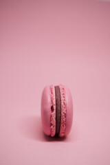 pink macaroon on a pink background. delicious fresh dessert. monochrome. color of the year. viva magenta