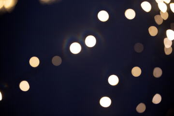 Blurred Christmas lights over dark blue background
