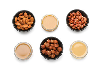 Different types of delicious nut butters and ingredients on white background, top view