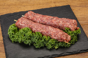 Raw minced beef kebab skewer