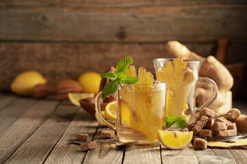 Ginger tea with ingredients on an old wooden table.