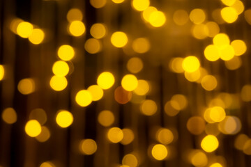 Gold bokeh background. blur abstract glowing  bright night effect defocused  circle. backdrop for decoration celebrate party holidays. merry christmas and happy new year 2022 concept.