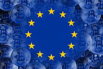 Hold the physical version of Bitcoin and the EU flag. Conceptual diagram of EU cryptocurrency and...