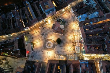 Aerial night view of the Council Square located in the historic center of Brasov city, Romania