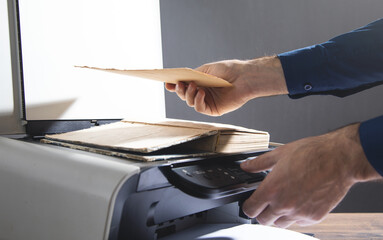Man copying a book on a copy machine.
