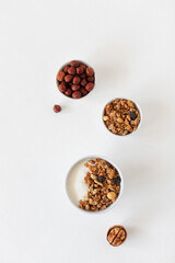 Yogurt, granola and nuts, breakfast on a light table. View from above. Copy space.