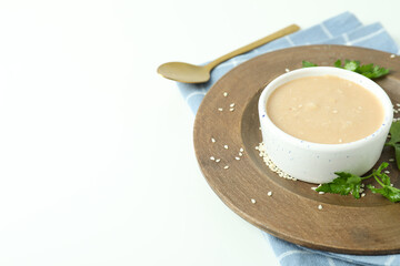 Concept of tasty food with tahini sauce on white background