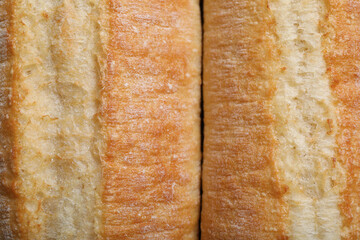 Tasty baguettes as background, top view. Fresh bread