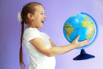 Fototapeta premium The globe is one of the main elements of education for a girl's child.