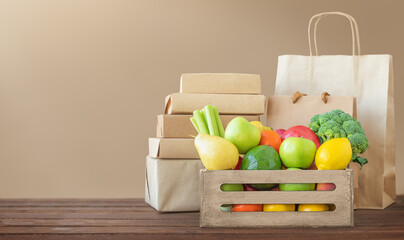 Concept of food delivery - fruit and vegetables and packages