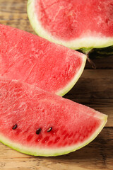 Delicious fresh watermelon slices on wooden table, closeup