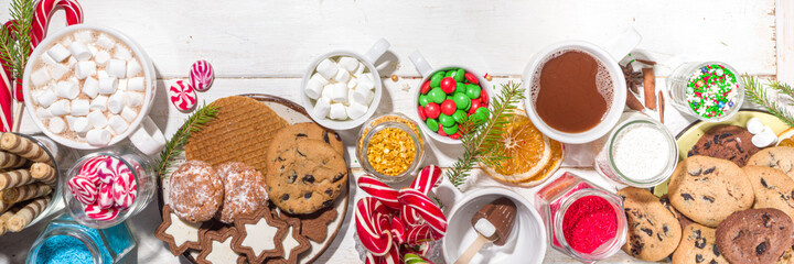 Christmas hot chocolate party bar, winter cocoa buffet with a lot of hot chocolate mugs, various...