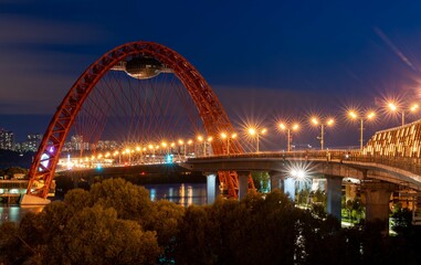 Obraz premium Beautiful bridge over the river in summer evening