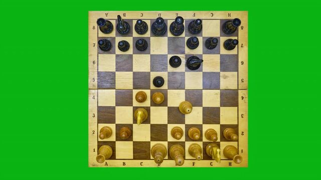 Vintage chess board with a queen gambit opening, stop motion on the green chromakey