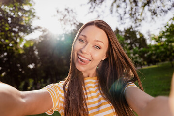 Self-portrait of attractive carefree funky cheerful girl having fun grimacing fooling good mood rest outdoors