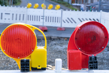 Red warning lamp at a construction site during the day