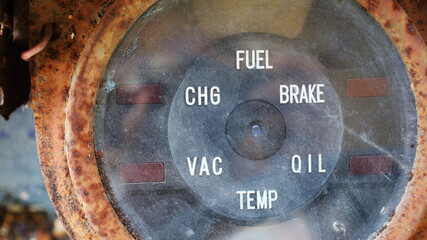 Close up old car gauges. The vintage dashboard of an old rusty truck or bus. Selective focus