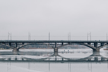 photo of the ice-covered river on which fishermen catch fish, but the ice has already begun to melt...