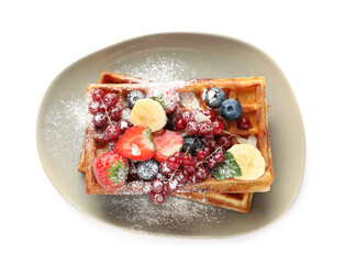Plate of delicious Belgian waffles with berries and powdered sugar isolated on white, top view