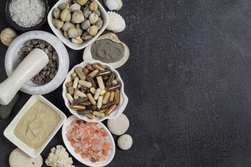 Dietary supplements in capsules, various crystals of salt and sea minerals in plates and in mortar