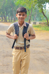 Indian school boy standing over nature background.
