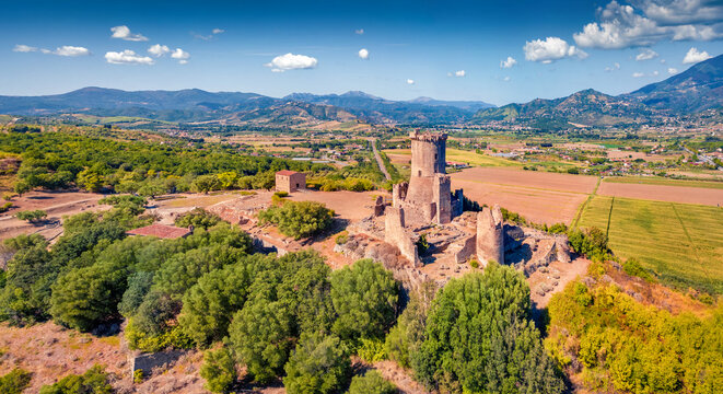 Fresh green summer view from flying drone of historical landmark - Velia Tower. Aerial morning scene of Parco Archeologico di Velia, Italy, Europe. Traveling concept background.