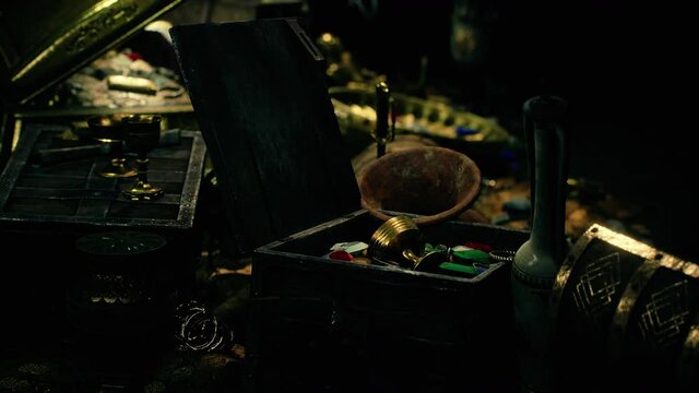 treasures in a dark cave with coins diamonds and gold