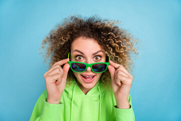 Photo of amazed lady look camera take off specs discount reaction wear green sweatshirt isolated pink color background