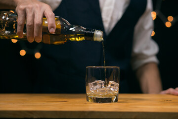 Barman pouring whiskey whiskey glass beautiful night