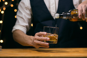 Barman pouring whiskey whiskey glass beautiful night