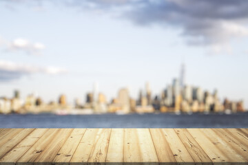 Wooden tabletop with beautiful blurry skyscrapers on background, mock up