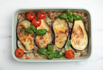 Delicious eggplant lasagna in baking dish on white marble table, top view