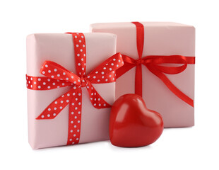Beautiful gift boxes with decorative red heart isolated on white