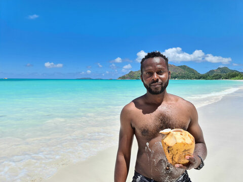Drinking coconuts on the best Beach in the world Gand Anse Praslin Seychelles 