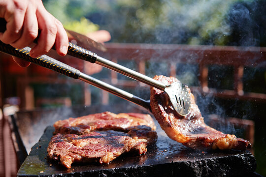 Barbecue Beef Burger Steak. Cutlet Meat Placed On Grill Stone With Fire.