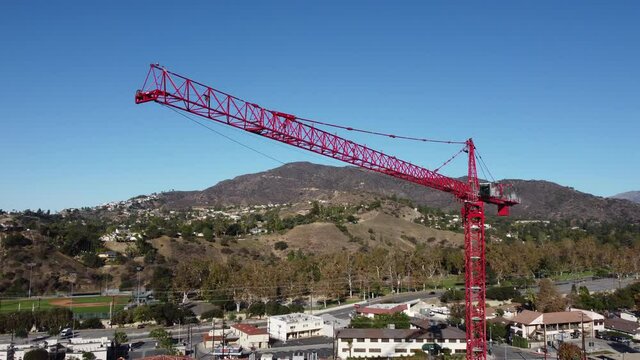 flying clockwise around red construction crane