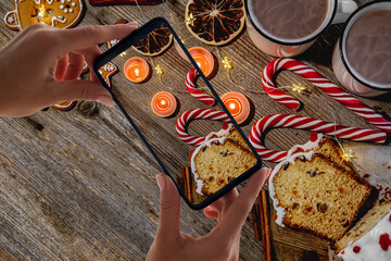 Festive gingerbread figures near candles and candies