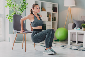 Photo of confident strong lady wear sport outfit smiling back chair sweating indoors home house