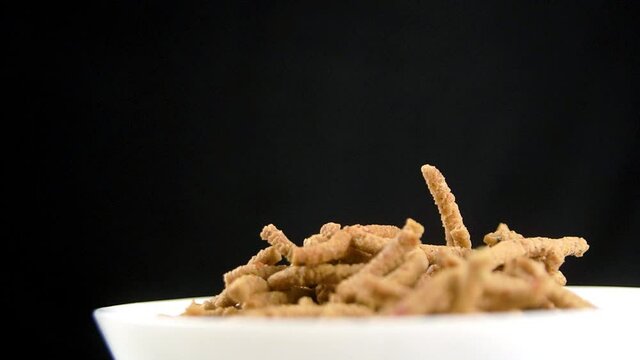 Close up of maruku falling or drop on top of each other in slow motion. Malaysian food and snack. Tempting and delicious food or snack. Hari Raya Aidilfitri food. Muslim food and snack.