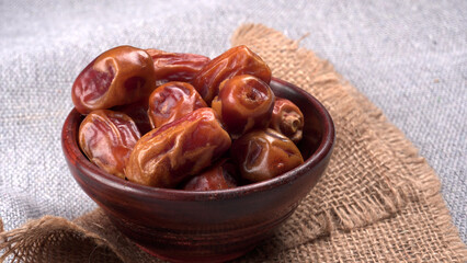 Dates in wooden bowl on background. dried dates fruit.