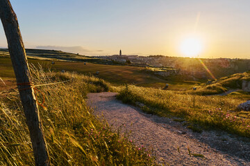 Summer landscape in Matera wheat fields, south Italy. Sunset in the sky.