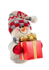 Smiling handmade snowman toy dressed in scarf and cap with red gift box with golden bow isolated on white background. symbol of Christmas and New year