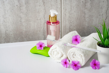 Obraz na płótnie Canvas Toothbrushes, soap and two towels. Rose flowers aromatherapy home