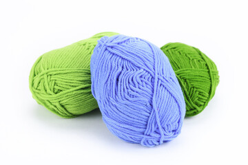 Multi-colored balls of wool on a white background. 